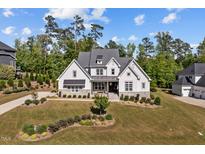 Beautiful two-story home featuring a manicured lawn and a stone-accented facade at 623 Westfall Way, Chapel Hill, NC 27517