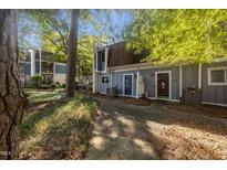Charming two-story townhouse with a well-maintained lawn and beautiful surrounding trees at 7020 Longstreet Dr # A, Raleigh, NC 27615