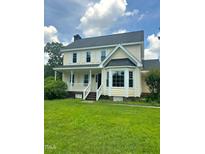 Charming two-story home with a front porch and manicured lawn exudes warmth and inviting curb appeal at 1109 Beechwood Dr, Rocky Mount, NC 27803
