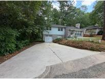 Charming two-story home with a stone facade, large driveway, and a well-maintained lawn at 2022 Bivins St, Durham, NC 27707
