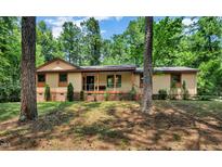 Charming single-story home featuring a welcoming screened porch and lush, wooded surroundings at 4134 King Charles Rd, Durham, NC 27707
