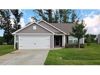 Charming single-story home with a two-car garage and well-manicured lawn at 50 Atlas Dr, Youngsville, NC 27596