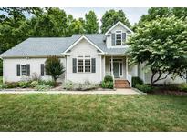 Charming single-Gathering home features a well-manicured lawn, welcoming front porch, and traditional architecture at 906 Stuart Dr, Mebane, NC 27302