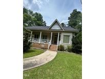 Charming single-story home featuring a covered porch, brick foundation and well-maintained lawn at 9160 Old Cascade Road Dr, Garner, NC 27529