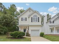Charming two-story home with white siding, a garage, manicured lawn, and tasteful landscaping at 137 Cricketgrass Dr, Cary, NC 27513