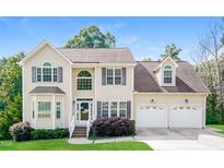 Inviting two-story home featuring a manicured lawn, classic shutters, and an attached two-car garage at 278 Victor Ct, Garner, NC 27529