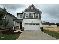 Charming two-story home with a welcoming two-car garage, and stone accents at 315 Gregory Village Dr, Lillington, NC 27546