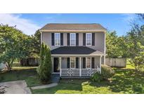 Charming two-story home with a covered front porch and well-manicured lawn at 7 Hannah Ct, Durham, NC 27713