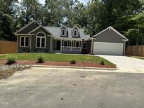 Charming new construction features welcoming front porch and attached two car garage at 820 E Cardinal Dr, Fuquay Varina, NC 27526