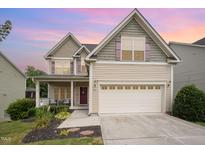 Charming two-story home featuring a two-car garage, covered porch and landscaped front yard at 832 Ribbonleaf Ln, Fuquay Varina, NC 27526