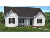 Charming single-story home with symmetrical design, vertical siding, and a covered front porch at 0 New King Rd, Smithfield, NC 27577