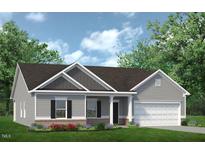 Charming one-story home with gray siding, brick accents, and a well-manicured lawn on a sunny day at 1234 Sirius Lot 6 Dr, Sanford, NC 27330