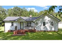 Charming single-story home with a metal roof, brick foundation, and inviting front porch at 202 Woodard St, Kenly, NC 27542