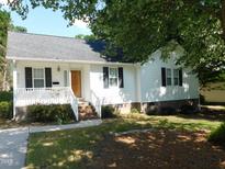 Charming white house with black shutters, front porch, and well-maintained landscaping at 204 Southland Dr, Zebulon, NC 27597