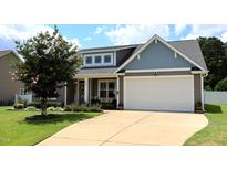 Charming home featuring a two-car garage, manicured lawn, and inviting curb appeal at 112 Star Valley Dr, Angier, NC 27501