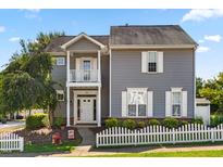 Charming two-story home with gray siding, white trim, and a well-maintained front yard at 185 Sioux Ln, Clayton, NC 27520