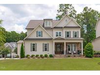 Charming two-story home with a welcoming front porch, stone accents, and manicured lawn at 2817 Walden Rd, Apex, NC 27502