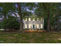 Charming two-story home with a landscaped yard and inviting curb appeal at 701 Oakhall Dr, Holly Springs, NC 27540
