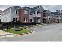 Brick apartment building with ample parking and landscaping at 403 Weather Ridge Ln # 42, Cary, NC 27513