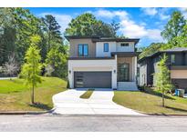 Striking modern home with a two-car garage, sleek gray door, manicured lawn, and a blend of textures on the facade at 2601 Mayview Rd, Raleigh, NC 27607