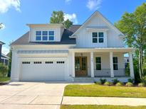 Beautiful two story home features a white exterior, attached garage and covered porch at 167 Edgefield St, Pittsboro, NC 27312