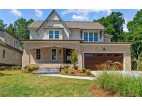 Two story home with brick and shingle exterior, landscaped yard, and attached two-car garage at 405 Bridgewater Dr, Sanford, NC 27330