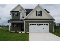 Charming two-story home with a two-car garage and a well-manicured lawn at 115 Grinnel Loop, Sanford, NC 27332