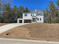 Beautiful two-story home with attached two-car garage and manicured lawn at 6298 Swanns Station Rd, Sanford, NC 27332