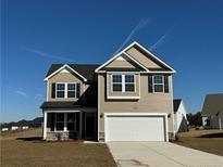 Two-story house with beige siding, a two-car garage, and landscaping at 30 Willow Walk (Lot 460) Way, Cameron, NC 28326