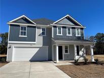 Two-story house with gray and blue siding, white garage door, and landscaping at 2833 Sheriff Watson Rd, Sanford, NC 27332