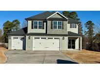 Two-story house with a gray exterior, two-car garage, and landscaping at 35 Fort Mcclary Ct, Cameron, NC 28326