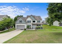 Charming two-story home with a well-manicured lawn, two-car garage, and inviting front porch at 40 Sedgefield Ln, Spring Lake, NC 28390