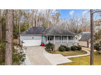 Ranch home with solar panels, front porch, and landscaped yard at 794 Cashmere Ct, Sanford, NC 27332