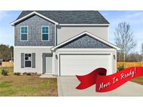 Two-story house with gray and white siding, a two-car garage, and a landscaped lawn at 41 Alderman (Lot 2) Ct, Dunn, NC 28334