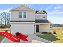 Two-story house with gray siding, a two-car garage, and a well-maintained lawn at 59 Marley (Lot 13) Way, Dunn, NC 28334