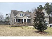 Two-story house with brick accents and a large front yard at 708 Omaha Dr, Broadway, NC 27505