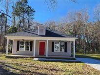 Gray house with red door, covered porch, and landscaped yard at 910 West St, Smithfield, NC 27577