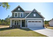 Charming two-story home with a two car garage and manicured front lawn at 2885 Lemuel Black Rd, Bunnlevel, NC 28323