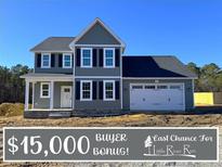 Two-story home with gray siding, white accents, and a two-car garage at 732 Burley Oak Dr, Cameron, NC 28326