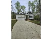Charming single-Gathering home with attached garage and a well-manicured lawn at 8022 Royal Dr, Sanford, NC 27332