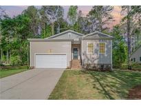 Charming home featuring a one-car garage, manicured lawn, and inviting front entrance at 8030 Turnberry Cir, Sanford, NC 27332