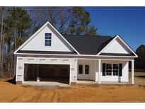 Newly constructed home with white siding, dark roof, and a two-car garage at 123 Nectar Ln, Bunnlevel, NC 28323