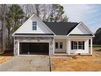 Charming new construction home with stone accents and an attached two-car garage at 123 Nectar Ln, Bunnlevel, NC 28323