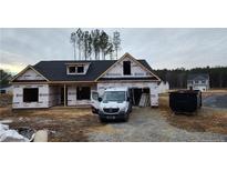 Newly constructed home with a two-car garage and covered porch at 174 Nectar Ln, Bunnlevel, NC 28323