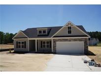 Charming single-Gathering home featuring stone accents and a two-car garage on a sunny day at 174 Nectar Ln, Bunnlevel, NC 28323