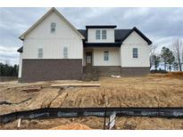 Two-story home with white siding, brick accents, and a covered porch at 196 Hook Dr, Fuquay Varina, NC 27526