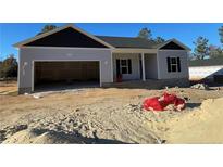 Newly constructed one-story home with gray siding and a two-car garage at 4983 (Lot 3) Ray Rd, Spring Lake, NC 28390