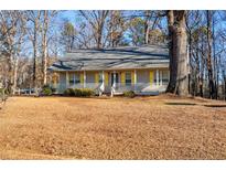 Ranch home with yellow shutters, front porch, and large yard at 505 Hiking Trl, Benson, NC 27504