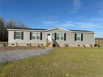 Gray manufactured home with black shutters and landscaping at 441 Hayes Rd, Spring Lake, NC 28390