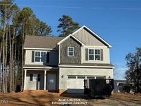 Two-story house with gray siding, vinyl windows, and a two-car garage at 60 Bennett Rd, Coats, NC 27521